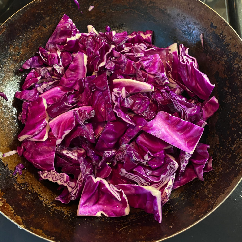 chopped red cabbage in a wok